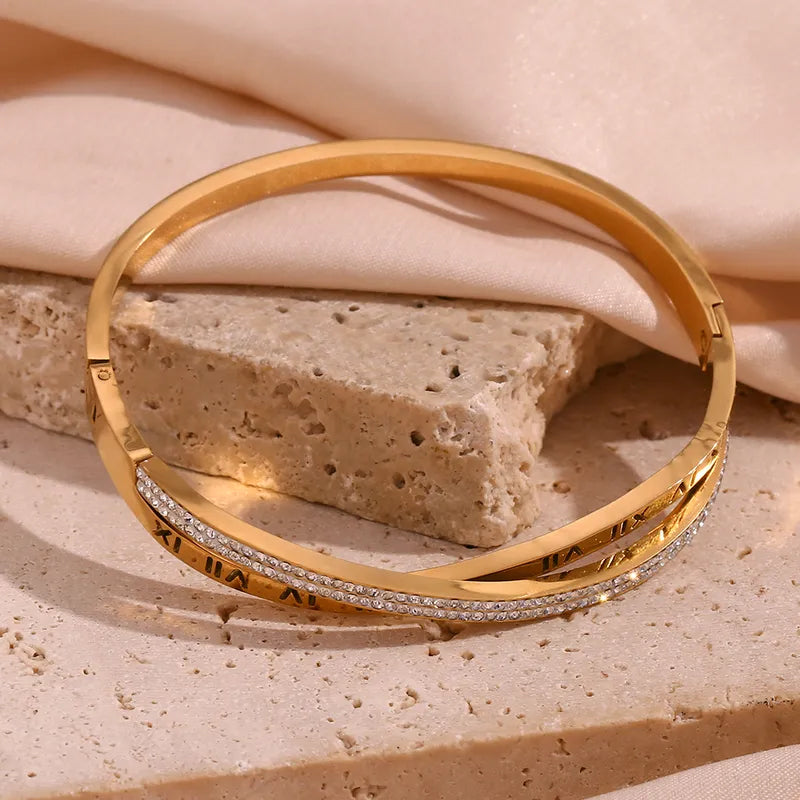 Adora London Athena Bangle 18K fold plated roman numeral detailed bangle with rhinestones in a stainless steel bangle