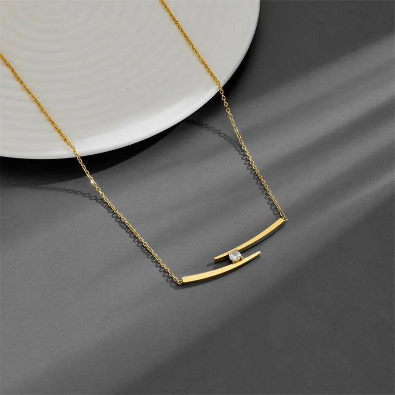 Adora London The Iris Necklace Simple style necklace with double gold plated detailing and gemstone detailing in the center