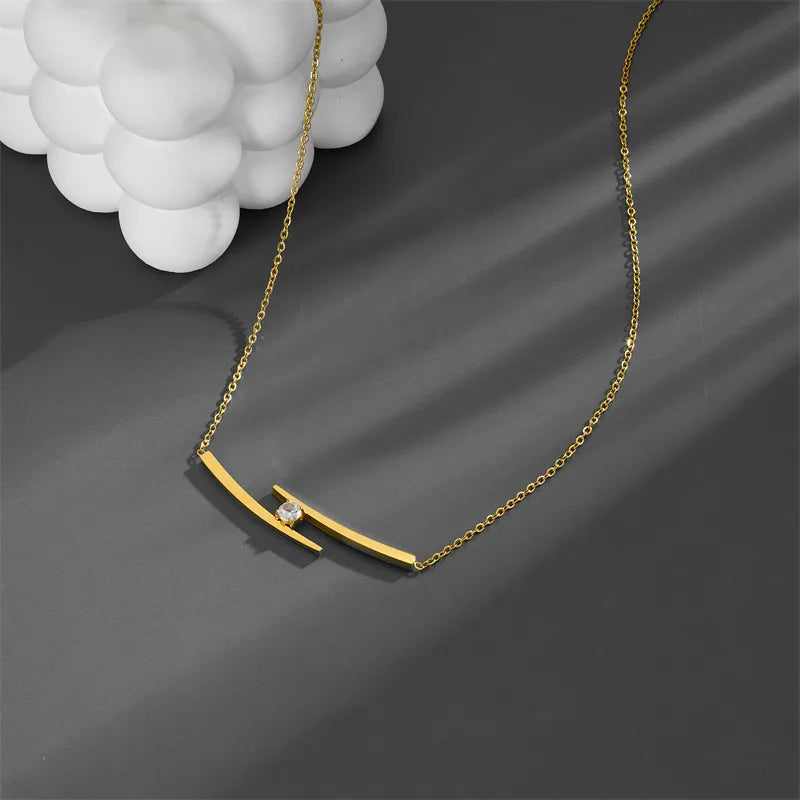 Adora London The Iris Necklace Simple style necklace with double gold plated detailing and gemstone detailing in the center