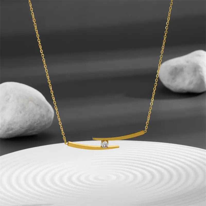 Adora London The Iris Necklace Simple style necklace with double gold plated detailing and gemstone detailing in the center