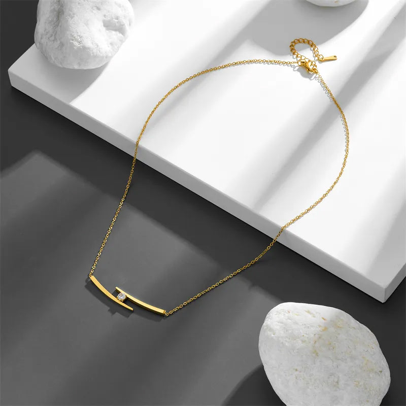 Adora London The Iris Necklace Simple style necklace with double gold plated detailing and gemstone detailing in the center